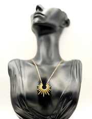 Waterproof gold sunburst spike pendant necklace in green gift box by Biya Accessoires.