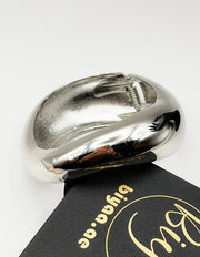 Non-tarnish thick silver statement bangle for women Dubai luxury fashion.