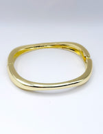 Gold bracelet on a white background
