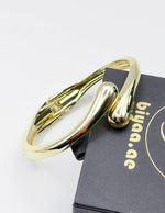 Non-tarnish sculptural wrap statement bangle for women Dubai luxury fashion bold