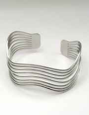 Silver wavy cuff bracelet on a white background