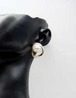 Close-up of premium hypoallergenic imitation jewelry featuring an asymmetrical pearl design.