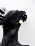 Biya Accessoires abstract gold and white enamel stud earrings.