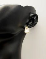 Best fashion jewelry in UAE white swirled enamel gold earrings for women.