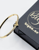 18K gold plated V motif chevron crystal bangle by Biya Accessoires.