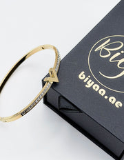 18K gold plated V motif chevron crystal bangle by Biya Accessoires.