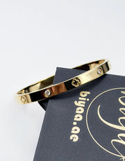 Hypoallergenic non-tarnish high polish gold rigid flat bangle UAE.
