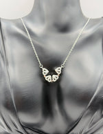 Modern luxury silver pavé clover statement necklace in gift box.