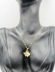 Waterproof gold and white floral necklace for women on silk background.