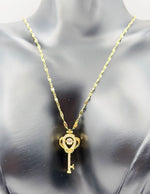 Modern luxury gold and pavé crystal royal key statement necklace.