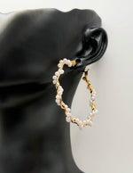 Close-up of lightweight hypoallergenic imitation jewelry featuring gold triangle earrings.