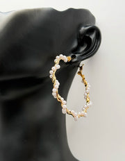 Close-up of lightweight hypoallergenic imitation jewelry featuring gold triangle earrings.