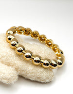 Non-tarnish chunky gold sphere cuff for women Dubai luxury fashion.