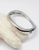 Metallic handle on a textured white object with a plain background