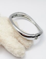 Metallic handle on a textured white object with a plain background