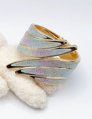 Non-tarnish sweeping fluid gold bangle with pearlescent inlay Dubai luxury fashion.