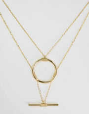 dainty gold necklace featuring circular and horizontal bar