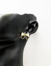 Everyday luxury fashion jewelry gold tone statement bow studs by Biya Accessoires Dubai.