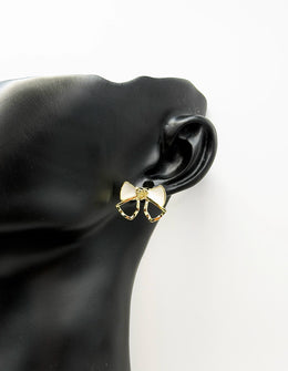 Everyday luxury fashion jewelry gold tone statement bow studs by Biya Accessoires Dubai.