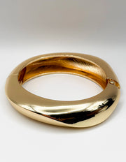 Gold bracelet on a white background