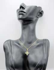 Mannequin wearing a gold necklace with a butterfly pendant on a gray background