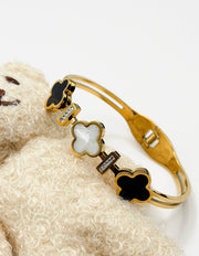 18K gold plated quatrefoil station split band bangle by Biya Accessoires.