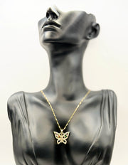 Waterproof gold butterfly necklace with rainbow marquise stones on white silk.