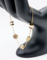 18K gold plated crystal cylinder and floral station bracelet by Biya Accessoires.