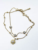 18K gold plated double chain pearl and flower bracelet by Biya Accessoires.