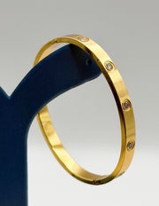 Hypoallergenic non-tarnish high polish gold rigid flat bangle UAE.