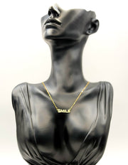 18K gold plated pavé crystal smile letter necklace by Biya Accessoires.