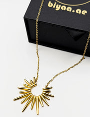 Edgy gold statement necklace with radiant spikes on display.