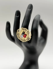18K gold plated openwork flower statement ring with three colored stones by Biya Accessoires.