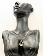 Waterproof mixed metal double loop necklace on gold snake chain.