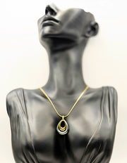 Waterproof mixed metal double loop necklace on gold snake chain.