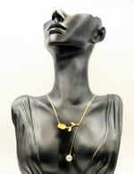 Biya Accessoires 18K gold plated tulip lariat necklace with pearl drop in green gift box.