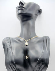 Waterproof non-tarnish artificial gold Y-drop necklace resting on taupe fabric.