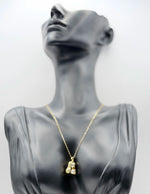 Waterproof non-tarnish artificial gold jewelry resting in a luxury green presentation box.