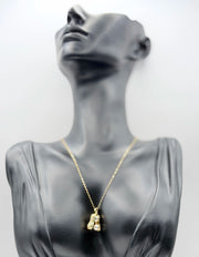 Waterproof non-tarnish artificial gold jewelry resting in a luxury green presentation box.
