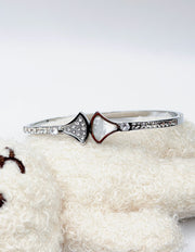 Silver ring with a heart-shaped gemstone on a white surface