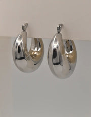 Silver bubble hoops on white background, clasp detail visible