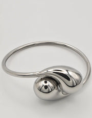 Side profile closeup of silver droplet bracelet curve