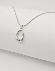 minimalist gold chain with a sleek round pendant inspired by montreal style