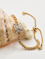 radiant_blossom_happy_face_bracelet_chic_floral_crystal_gold_slider_design