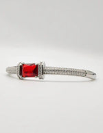 “Luxury silver women’s bracelet with bold red gemstone and Canadian-inspired modern jewellery design.”