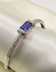 “Canadian women’s silver bracelet featuring radiant blue crystal, sleek loom design, and sparkling cubic zirconia details.”