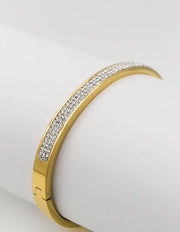 Close-up of luxury golden bangle with diamond-like stones