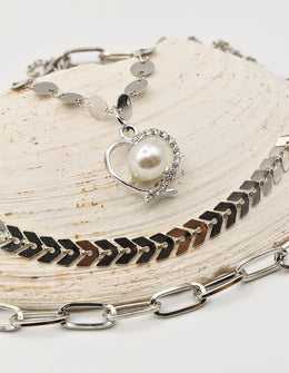 close up of christmas necklace with pearl heart pendant on silver layered chains – trending clean girl jewelry 2025 in canada