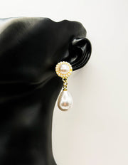 Close up of elegant imitation jewelry uae featuring a pearl stud halo and teardrop dangle.
