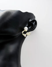 Close up of elegant imitation jewelry uae featuring a pavé crystal flower and faux pearls.